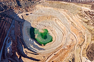 Mining quarry, aerial view. Industrial production and transportation of minerals, ore and gravel
