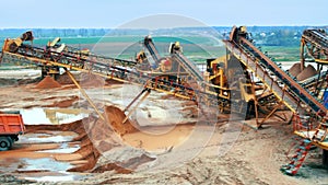 Mining site with heavy industrial equipment. Mining elevator with belt conveyor