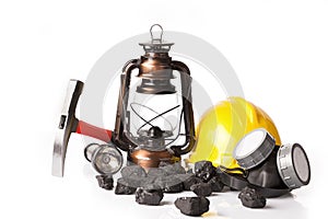 Mining tools with protective helmet, ear muffs and oil lantern photo