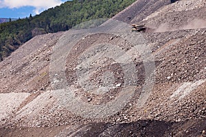 Mining truck on haul road at tailings hill side