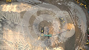 Mining truck transporting sand at sand quarry aerial view of mining machinery moving at sand mine top view of mining equipment at