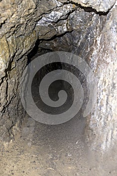 Mining tunnel bores through rock inside a mountain