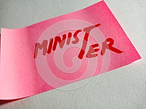 minister political word displayed on pink paper slip on white paper