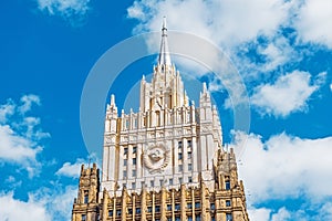 Ministry of Foreign Affairs of Russia style of Stalinist architecture against a blue sky with white clouds.