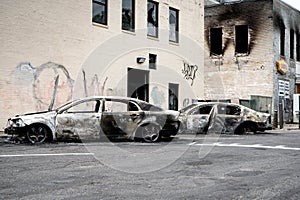 Burned down damaged cars in the morning after looting and minneapolis riots for George Floyd protests