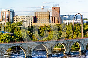 Minneapolis, MN, river and bridge with runner near downtown