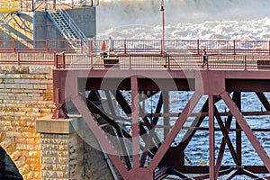 Minneapolis, MN, river and bridge with runner near downtown