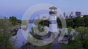 Minneapolis Skyline and Boom Island Lighthouse over the Mississippi River and Bridges at Dusk Day to Night 4K UHD Timelapse