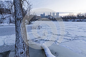 Minneapolis skyline and frozen mississippi river at dusk