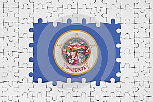 Minnesota US state flag in frame of white puzzle pieces with missing central part