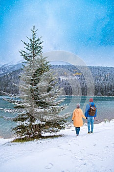 Minnewanka lake in Canadian Rockies in Banff Alberta Canada with turquoise water is surrounded by coniferous forests