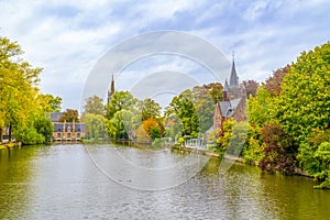 Minnewater castle at the Lake of Love during fall, Bruges, Belgium