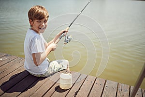 Minor caucasian boy fishing at the river