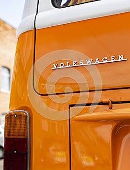 Minsk, Belarus, August 14 2018 - Orange Volkswagen Type 2 VW T2 logo parked on the street, known as the Transporter