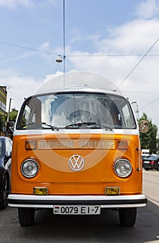 Minsk, Belarus, August 14 2018 - Orange and white Volkswagen Type 2 VW T2 parked on the street, known as the Transporter