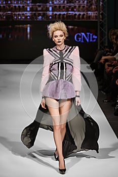 Minsk, Belarus - December, 15: Fashion model walks  on runway in fur coat at GNL show Fall-Winter 2016-2017 collection