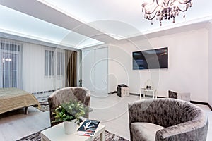 MINSK, BELARUS - January, 2019: luxure hall interior loft flat apartments with tv sofa and armchairs