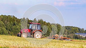 Minsk region, Belarus - August 05, 2017: Tractor works in the field. Plowing the land. Agriculture