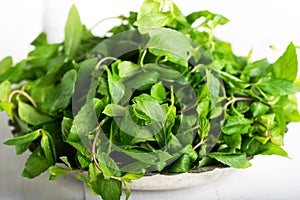 Mint. Bunch of Fresh green organic mint leaf in bowl on wooden table closeup