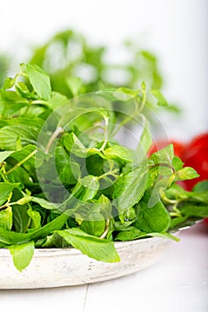 Mint. Bunch of Fresh green organic mint leaf in bowl on wooden table closeup