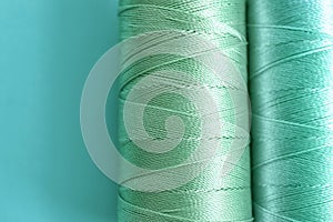 Mint color sewing threads on table