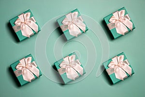 Mint gift boxes over the green background, birthday theme.