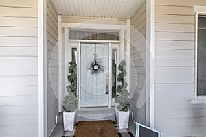 Mint green front door with transom window and two side panels