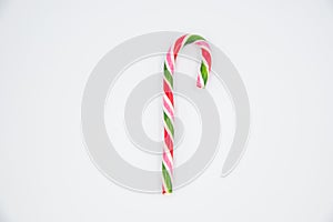 Mint hard candy cane striped in Christmas colours isolated on a white background. Closeup