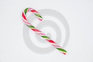 Mint hard candy cane striped in Christmas colours isolated on a white background. Closeup