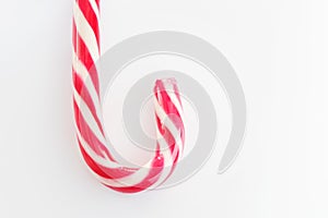 Mint hard candy cane striped in Christmas colours Red and White isolated on white background. Traditional Merry Christmas edible