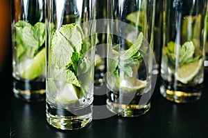 Mint ice and lime in the glasses. Close-up.