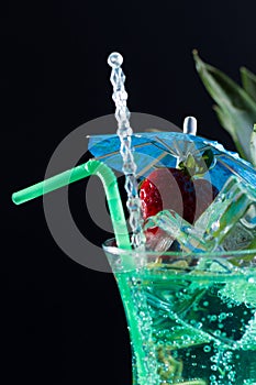 Mint, strawberry and pineapple cocktail over black