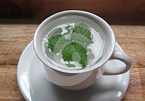 Mint tea, leaves resting on water photo