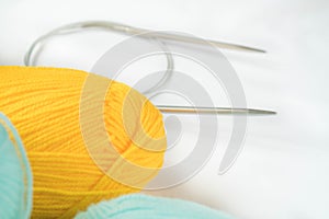 Mint and yellow acrylic yarn on a white background,with copyspace. Beautiful yarn for knitting baby clothes. For yarn, children`s