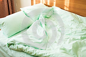 Minty green bedding on the bed