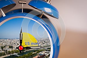 Ringing twin bell vintage classic alarm clock with the 15 minute city concept. photo
