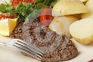 Minute steak meal closeup with fork