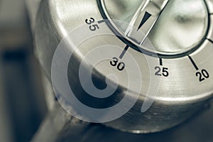 30 Minutes - Half Hour - Macro Of An Analog Chrome Kitchen Timer On Wooden Table