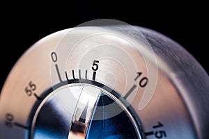 5 Minutes - Macro Of An Analog Chrome Kitchen Timer With Dark Background