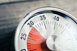 30 Minutes - Macro Of An Analog Timer On A Wooden Floor photo