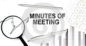 MINUTES OF MEETING document with pen,graph and magnifier,calculator