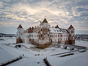 The Mir castle under the winter sunset sky