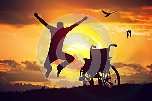 A miracle happened. Disabled handicapped man is healthy again. He is happy and jumping at sunset
