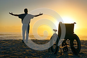 Miracle spiritual healing crippled man walking at beach at sunrise photo