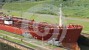 Red large cargo ship entering Miraflores Locks