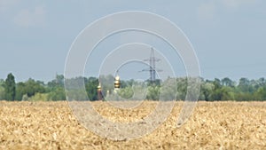 Mirage or heat waves over field with harvested crop of grain crops on extreme hot summer weather
