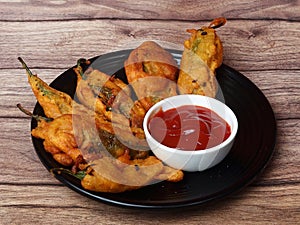 Mirchi pakora or Mirchi bhajji served with sauce, a famous midday snack in india photo
