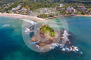 Mirissa sandy Parrot Rock island landmark aerial photo with a beautiful bay in Matara District on Sri Lanka. Exotic Asian