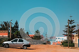 Mirleft, Morocco - relaxed residential neighborhood with low houses, pine trees, and cliffside view of Atlantic Ocean. photo