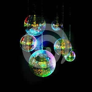 Mirror balls above dance floors. Awesome image of kaleidoscopic-looking disco balls hanging against a black background.